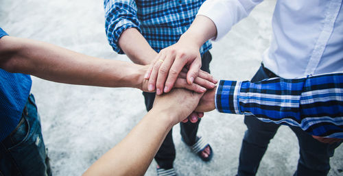 Midsection of couple holding hands