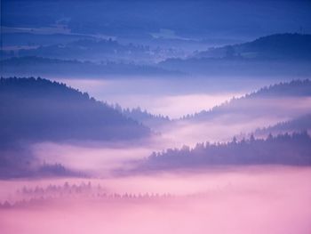 Pink daybreak in hilly landscape. autumn misty morning in a beautiful rocky hills. peaks of hills 