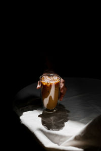 Close-up of coffee on table against black background