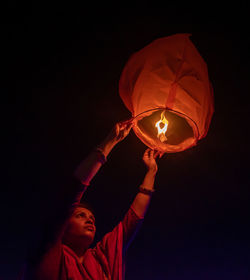 Close up of women holding sky lantern