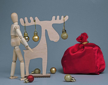 Close-up of figurine on table against colored background