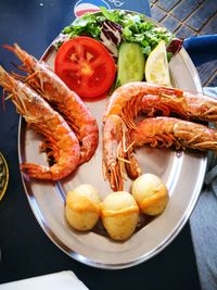 Close-up of seafood with salad in plate on table