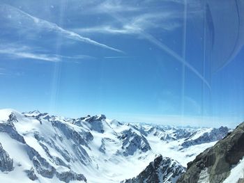 Scenic view of snow covered mountains against sky