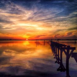 Pier on sea at sunset