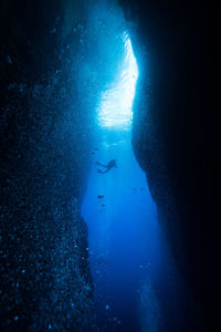 Person scuba diving at deep sea