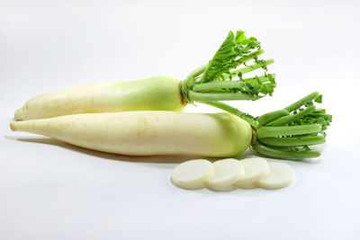 Close-up of green chili pepper against white background