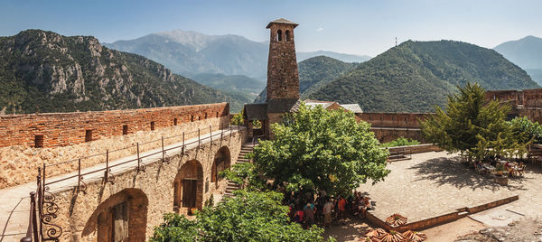 Panoramic view of trees and buildings against sky