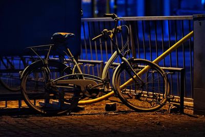 Bicycle parked against railing in city