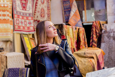 Young woman looking away at store