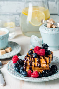 Close-up of fruits in plate on table