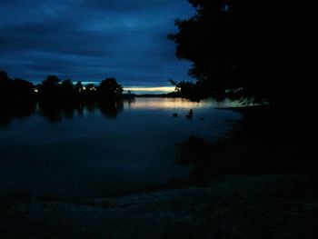 Scenic view of lake against sky at night