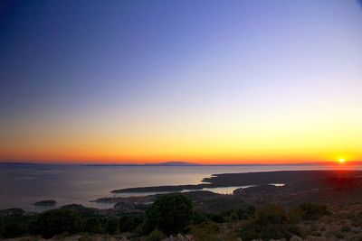 Scenic view of sea against clear sky during sunset