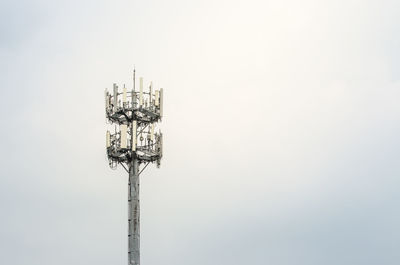 Low angle view of communications tower against sky