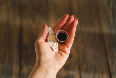 Cropped hand of woman holding seashell