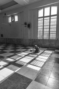 Shadow of man sitting on floor in abandoned building