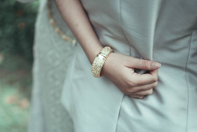 Midsection of groom with bride