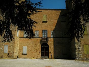 Trees and building against sky