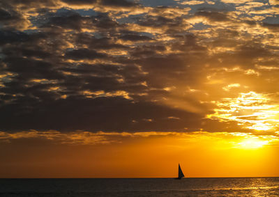 Scenic view of sea against orange sky