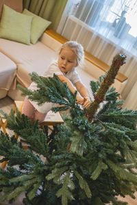 Portrait of cute girl decorating christmas tree