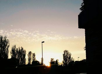 Silhouette of building against sky at sunset