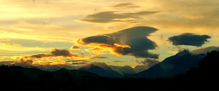 Scenic view of silhouette mountains against sky during sunset