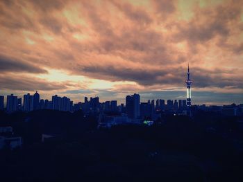 View of cityscape against cloudy sky