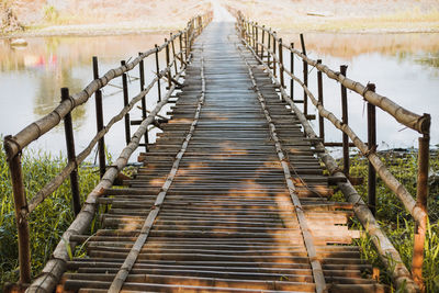 Bamboo footbridge over river in yogyakarta, indonesia