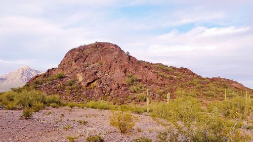 Rock formations on landscape against sky