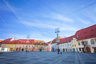 Buildings in town against blue sky