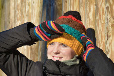 Smiling woman wearing knit hat looking away