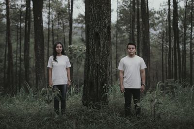 Full length of man standing on field in forest