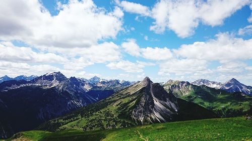 Scenic view of mountains against cloudy sky