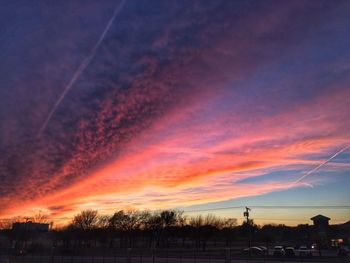 Low angle view of silhouette trees against sky at sunset