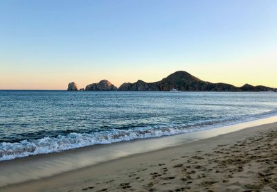 Scenic view of sea against clear sky during sunset