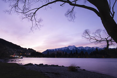 Scenic view of lake against sky at sunset