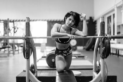 Woman in sports clothing exercising at health club