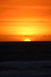 Scenic view of sea against romantic sky at sunset