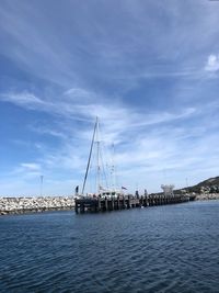 Sailboats in sea against sky