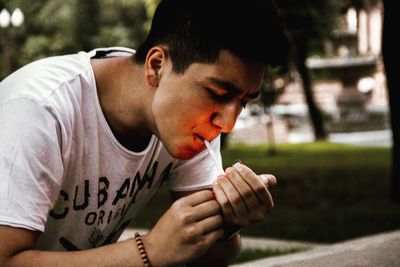 Portrait of young man sitting outdoors