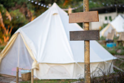 Close-up of cross against white wall