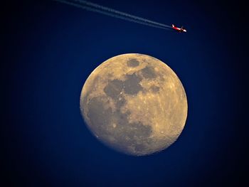 Low angle view of moon against clear sky at night