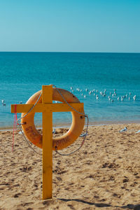 Lifeguard hut on beach against clear sky