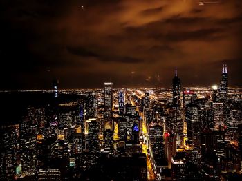 High angle view of city lit up at night