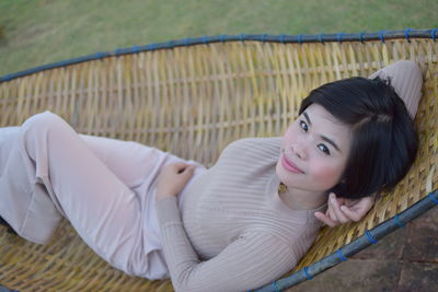 Portrait of a smiling young woman lying down