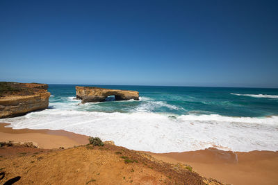 Scenic view of sea against clear blue sky