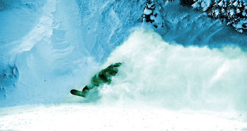 Snowboarder making a powder turn