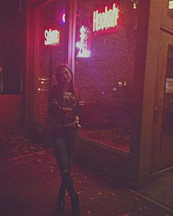 Full length of woman standing in illuminated building