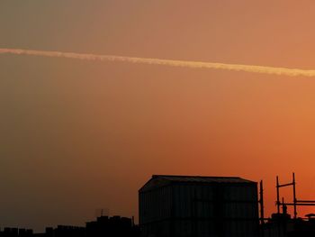 Low angle view of buildings against sky during sunset