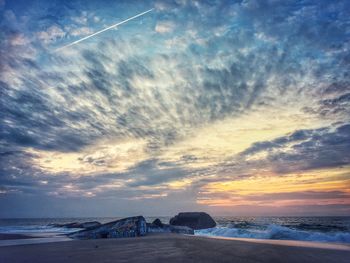 View of calm beach at sunset