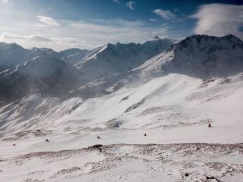 Scenic view of snow covered mountains against sky